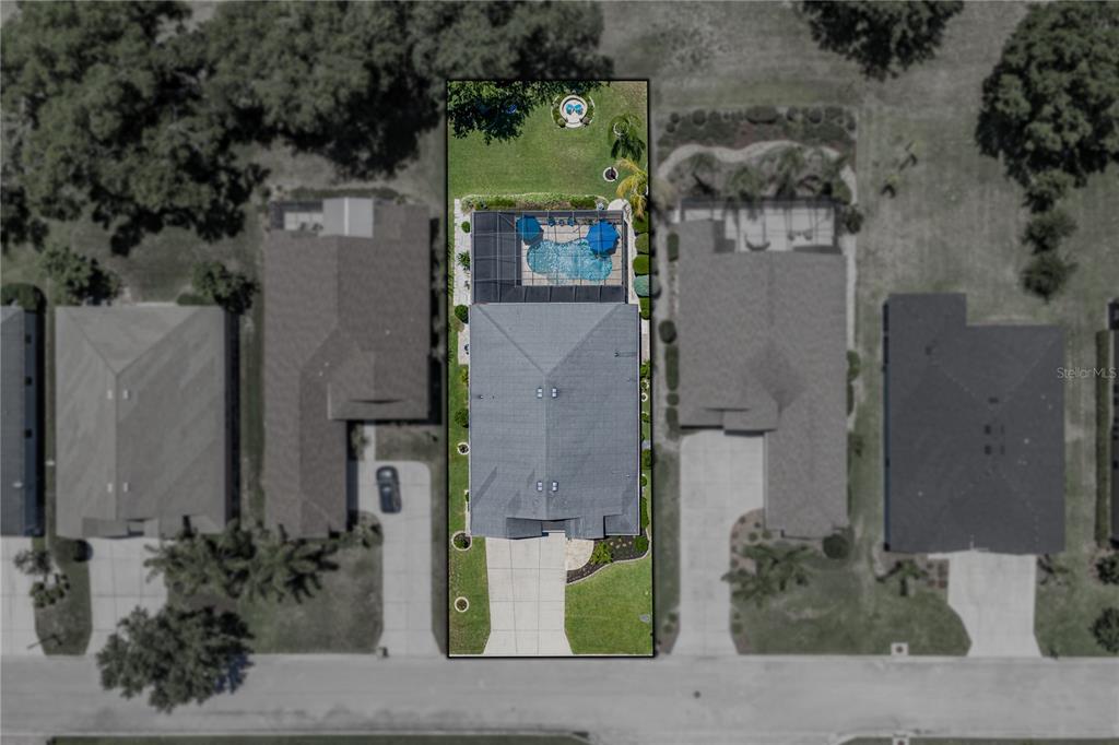 This is an aerial view of a residential property featuring a house with a pool — 34530 HEAVENLY LANE, DADE CITY, FL