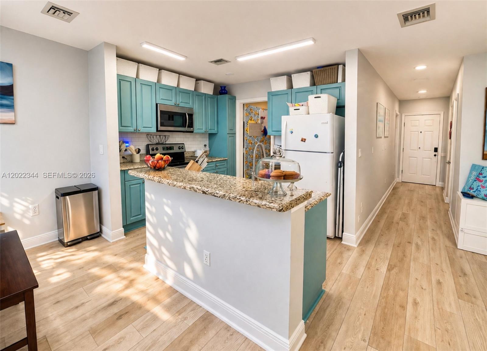 A two-story townhouse with a tile roof, two garage doors, and palm trees in front — 6613 Old Farm Trl, Boynton Beach FL 33437, BOYNTON BEACH, FL