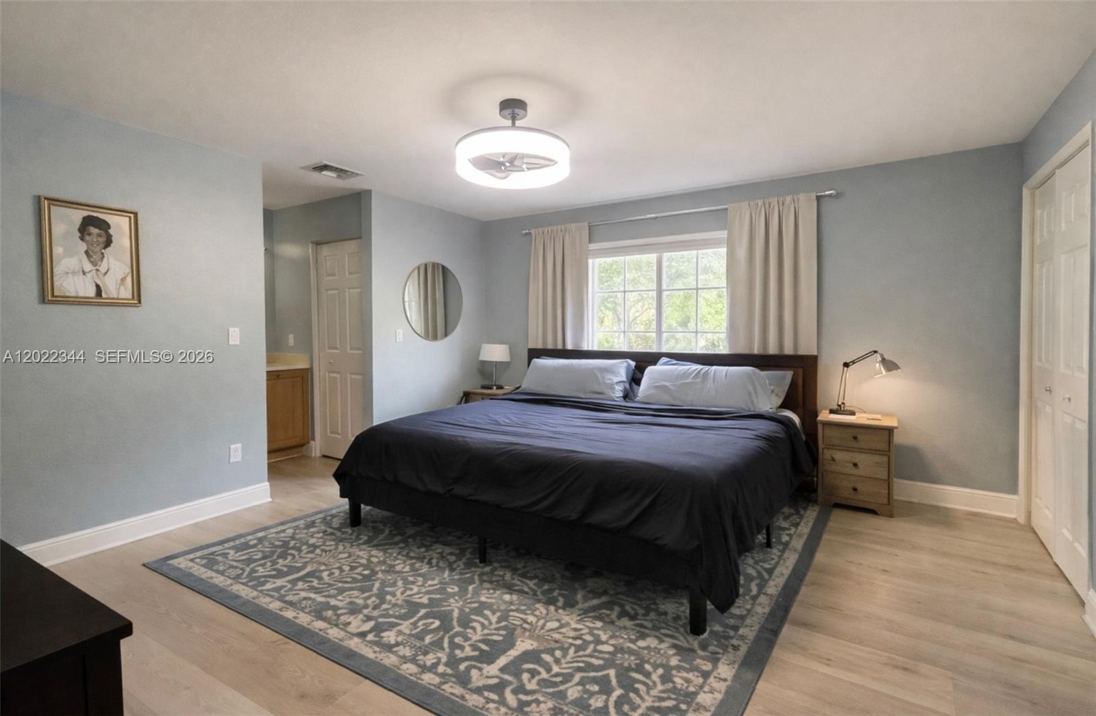 A kitchen features teal cabinets, granite countertops, and a peninsula with a breakfast bar — 6613 Old Farm Trl, Boynton Beach FL 33437, BOYNTON BEACH, FL