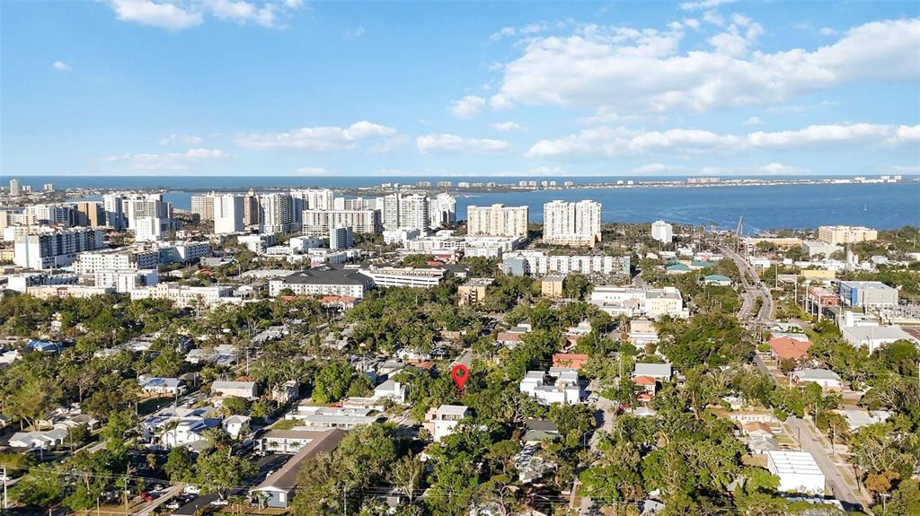 An aerial view shows a residential neighborhood with a red pin marking a specific property — 1743 8TH STREET, SARASOTA, FL