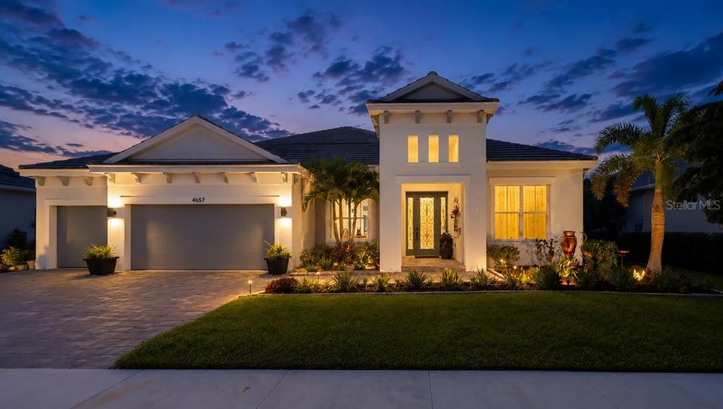 A single-story house with a garage, a central tower entrance, and a landscaped front yard — 4657 ANTRIM DRIVE, SARASOTA, FL
