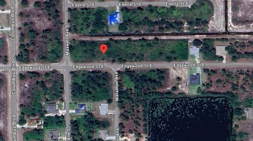 This is an aerial map view of a vacant, wooded residential lot marked with a pin — 1219 EDGEWOOD STREET E, LEHIGH ACRES, FL
