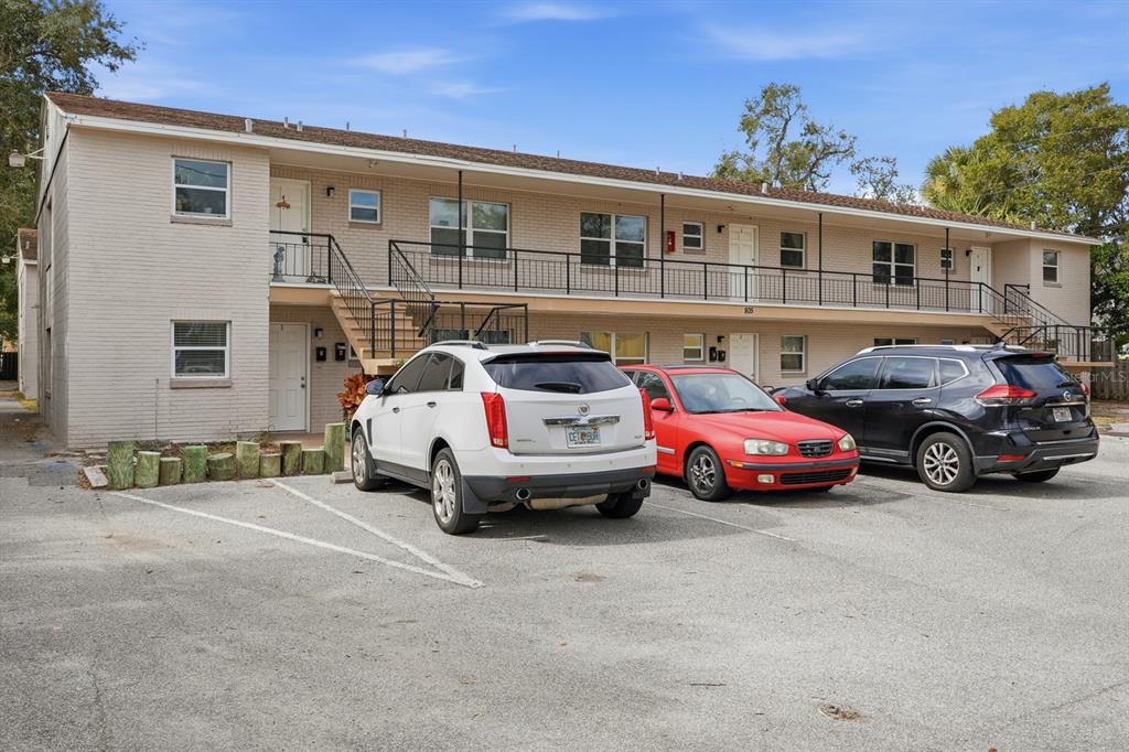 A two-story brick apartment building with an exterior staircase and a paved parking lot — 805 LOUISVILLE STREET, PORT ORANGE, FL