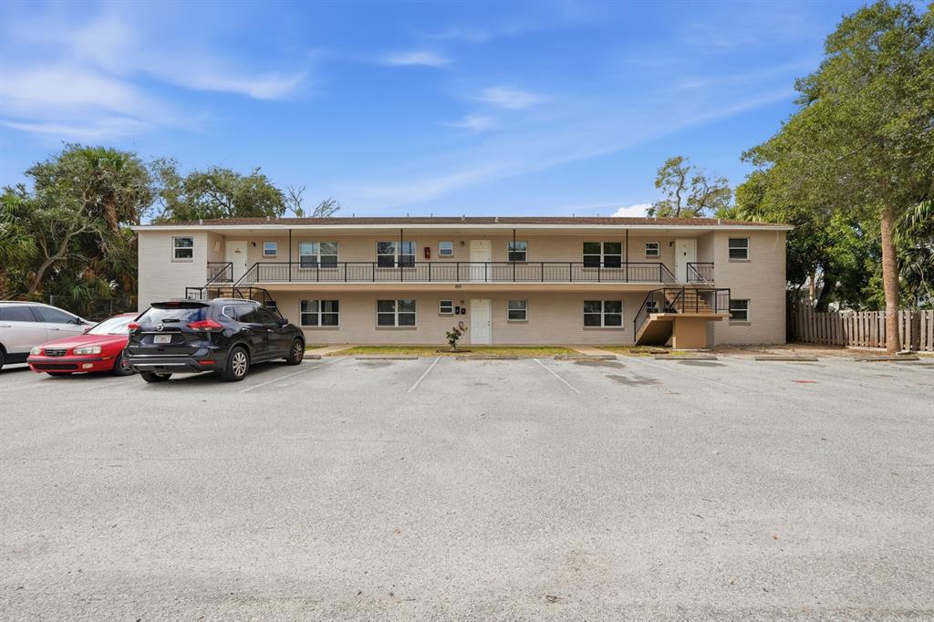 A two-story apartment building with a parking lot in front and exterior staircases — 805 LOUISVILLE STREET, PORT ORANGE, FL