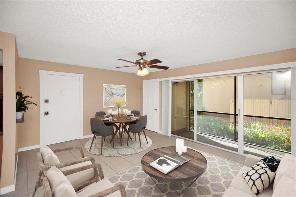 A dining and living area with tile floors, a ceiling fan, and sliding glass doors — 596 ORANGE DRIVE UNIT 150, ALTAMONTE SPRINGS, FL