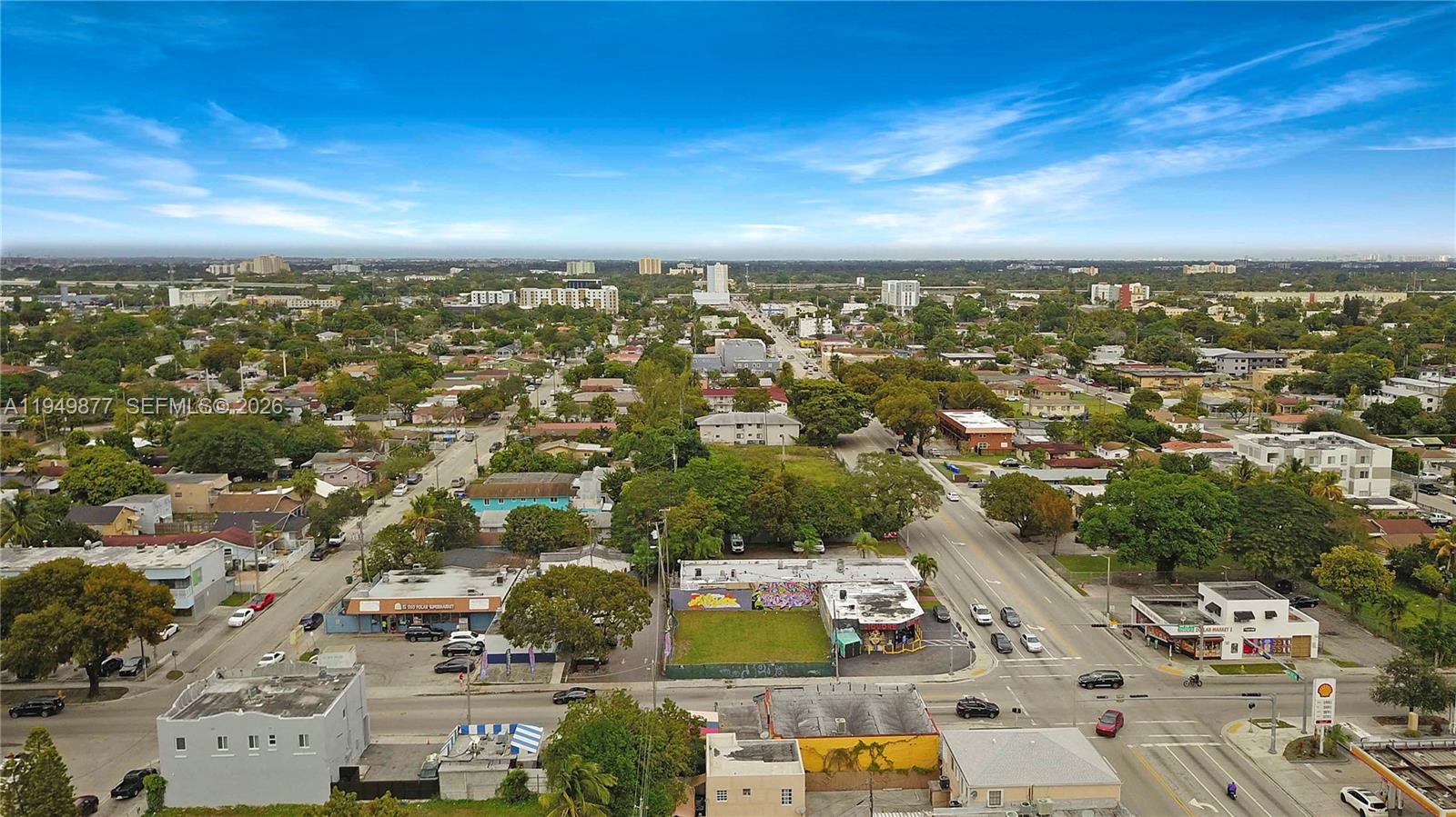 An aerial view shows a commercial corner lot with a mural-covered building and surrounding neighborhood — 2219 NW 28th St, Miami FL 33142, MIAMI, FL