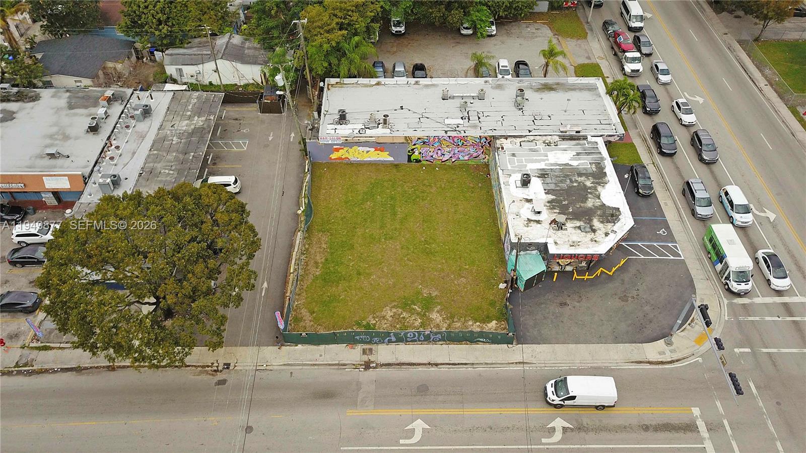 An aerial view shows a vacant rectangular lot situated between two commercial buildings — 2219 NW 28th St, Miami FL 33142, MIAMI, FL