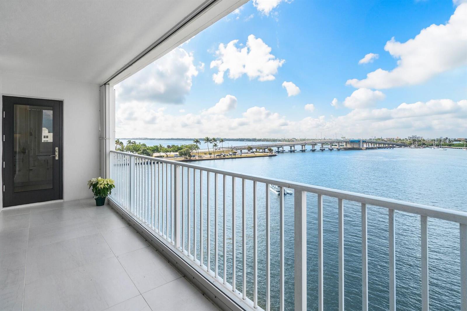 A balcony with white railings overlooks a body of water and a bridge — 2860 S Ocean Boulevard # 506, Palm Beach FL 33480, PALM BEACH, FL