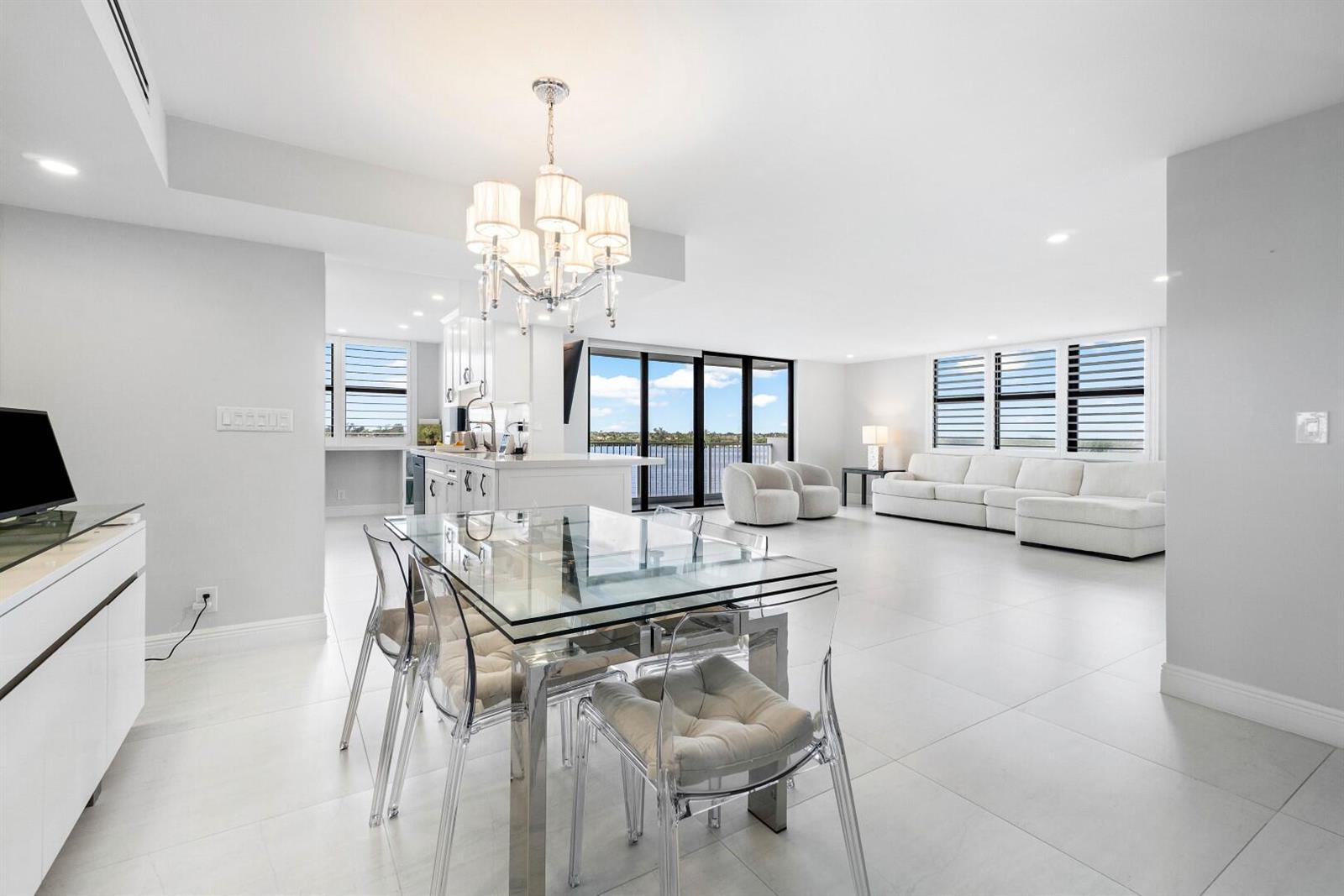 A bright, open-concept living and dining area features white tile floors and a glass table — 2860 S Ocean Boulevard # 506, Palm Beach FL 33480, PALM BEACH, FL
