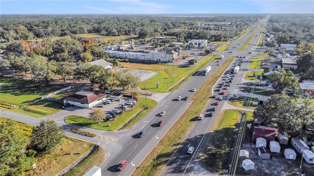 An aerial view shows a commercial building and parking lot adjacent to a busy highway — 0 US-98, LAKELAND, FL