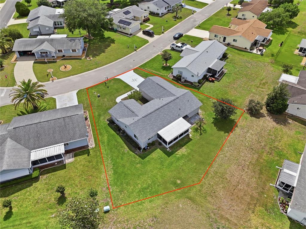 An aerial view shows a single-story house with a screened patio on a corner lot — 17814 SE 107TH TERRACE, SUMMERFIELD, FL