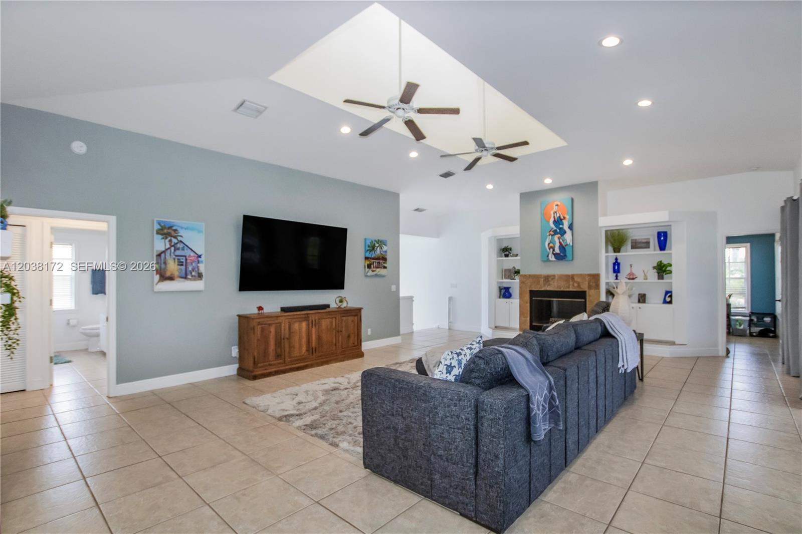 A living room features a large gray sofa, a fireplace, and a vaulted ceiling — 14500 bokeelia rd, Bokeelia FL 33922, BOKEELIA, FL