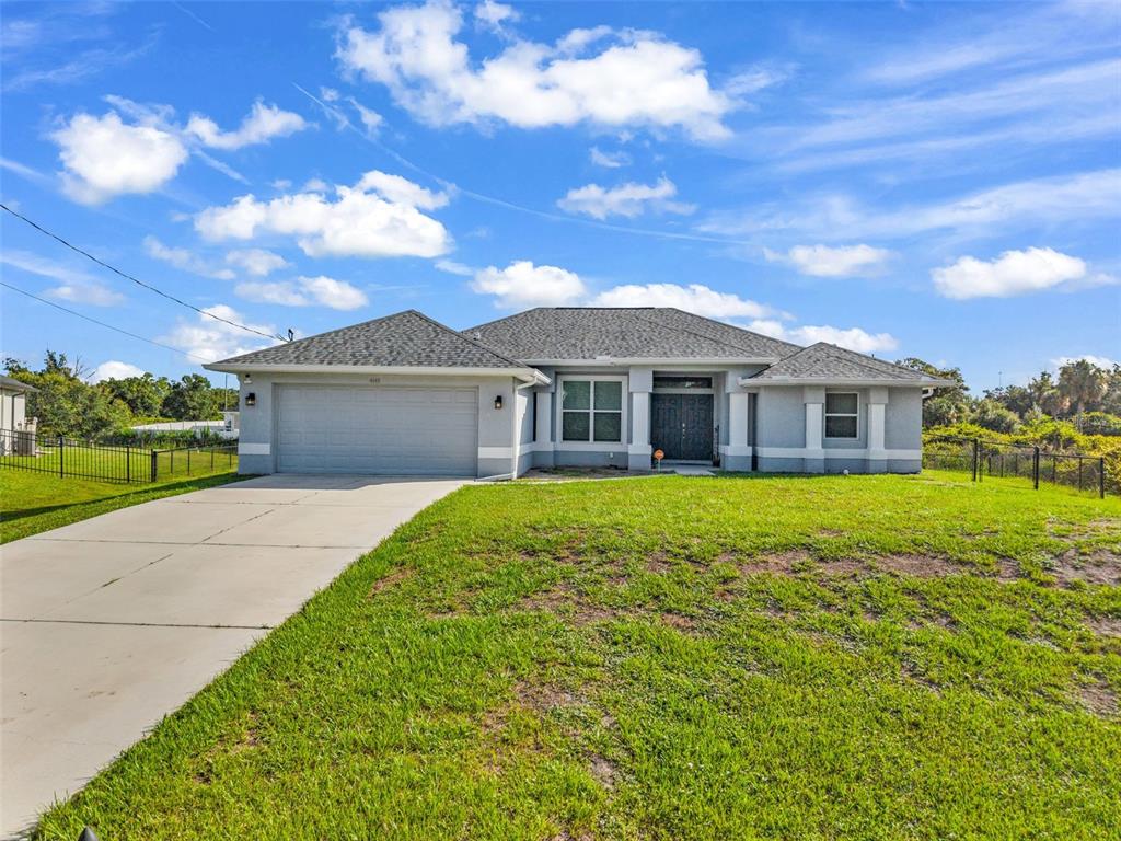 A single-story house with a gray exterior, a two-car garage, and a concrete driveway — 4443 CINDERELLA CIRCLE, NORTH PORT, FL