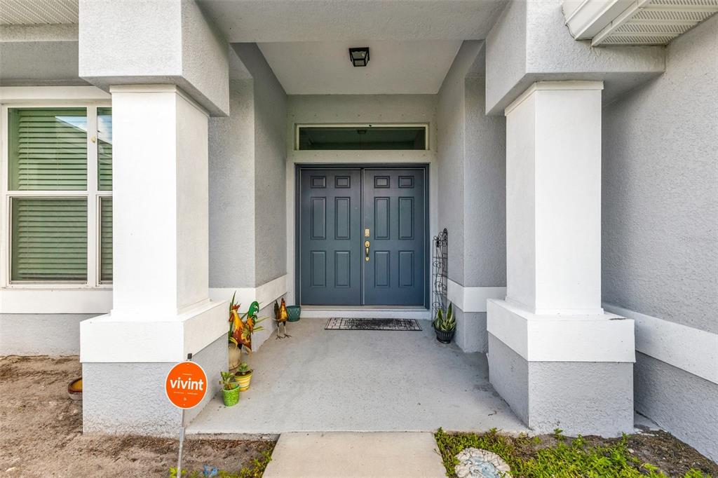 The front entrance features a double door, two large columns, and a Vivint security sign — 4443 CINDERELLA CIRCLE, NORTH PORT, FL