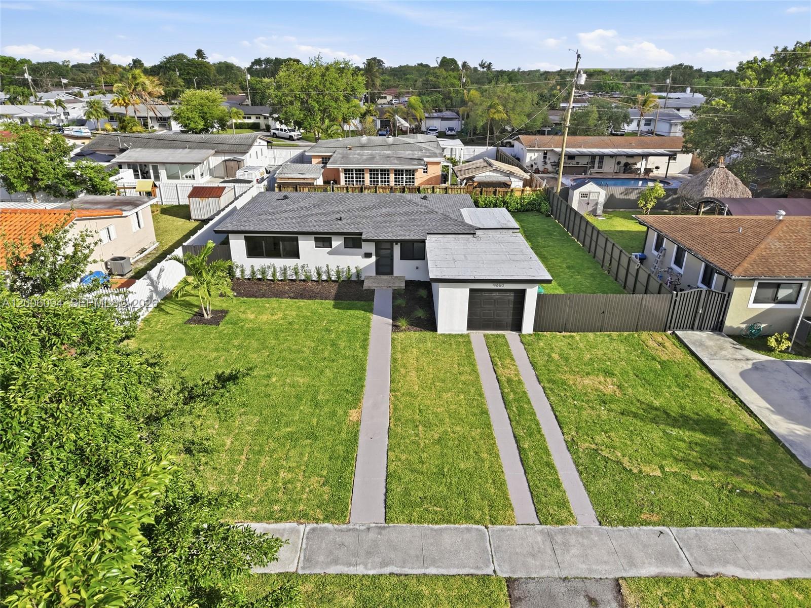 An aerial view shows a single-story house with a gray roof, white exterior, and garage — 9660 Dominican Dr, Cutler Bay FL 33189, CUTLER BAY, FL