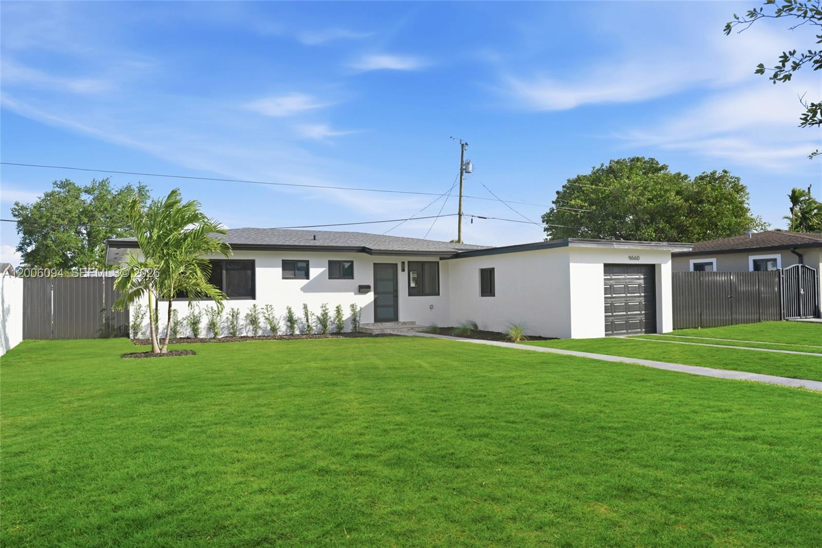 A white single-story house with a flat roof, a garage, and a large front lawn — 9660 Dominican Dr, Cutler Bay FL 33189, CUTLER BAY, FL