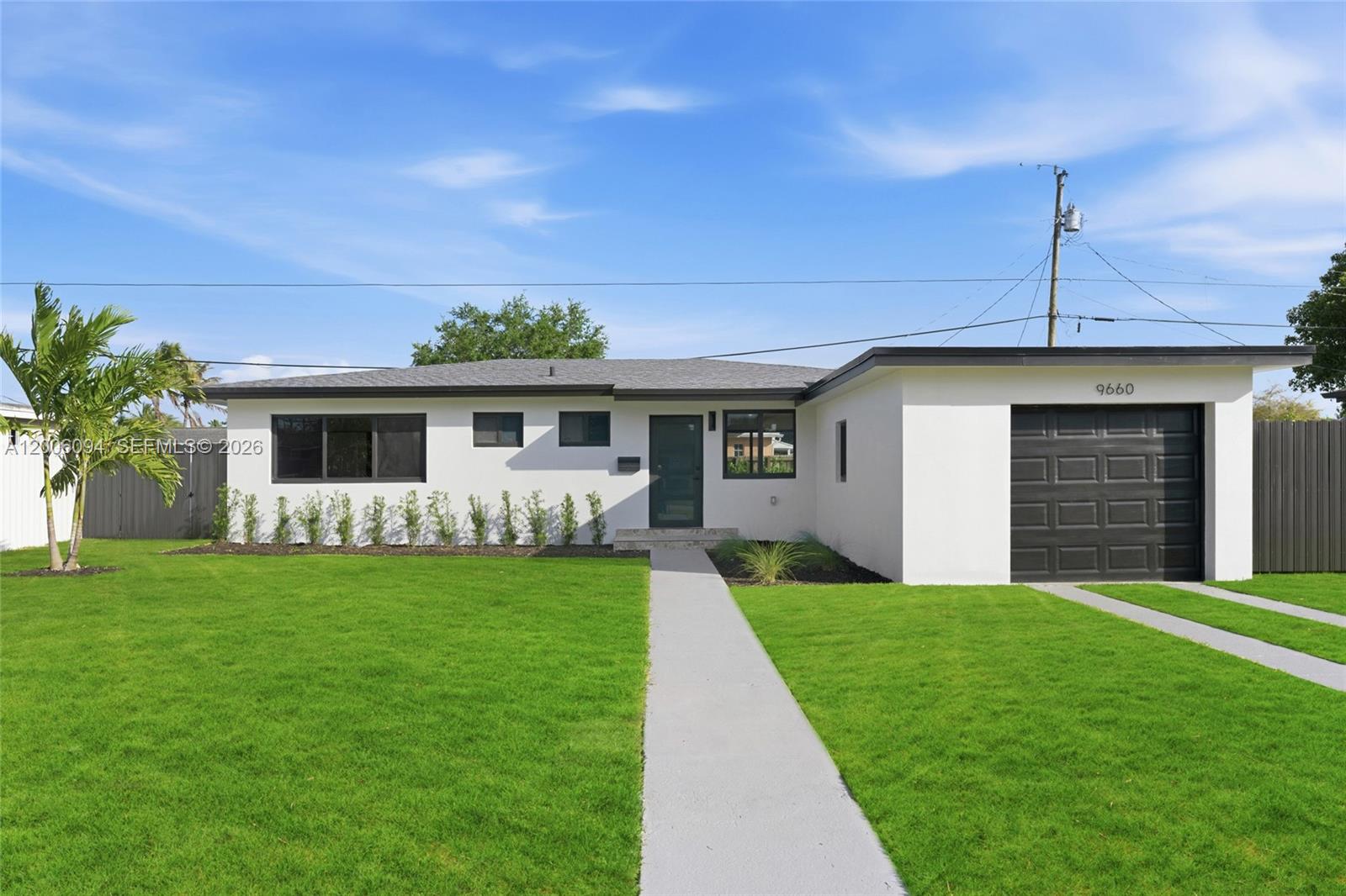 A single-story house with a white exterior, dark trim, and a front-facing garage — 9660 Dominican Dr, Cutler Bay FL 33189, CUTLER BAY, FL