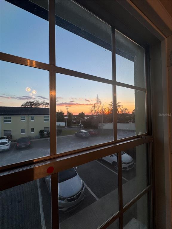 A view of a parking lot and sunset through a multi-pane window — 1500 GAY ROAD UNIT 20D, WINTER PARK, FL