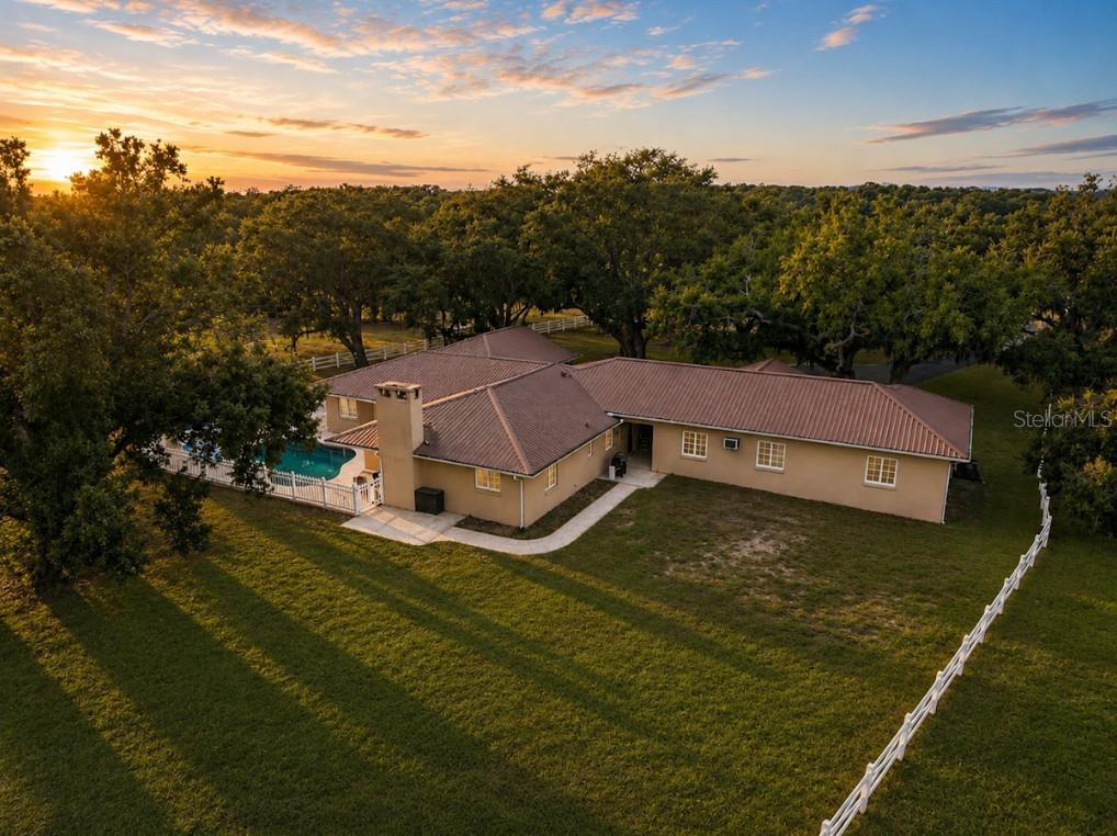 An aerial view of a single-story house with a tile roof and a backyard pool — 1160 WAGON WHEEL DRIVE, SARASOTA, FL