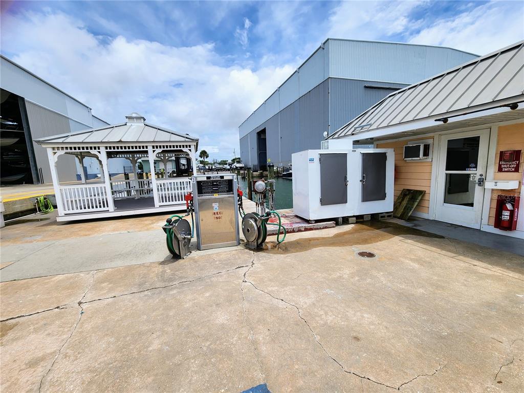 An outdoor fueling station sits on a concrete dock near a gazebo and storage building — 100 CIRCUIT ROAD UNIT N12, NOKOMIS, FL