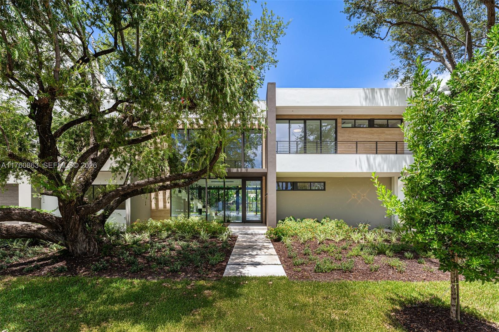 A modern two-story house with a flat roof, glass facade, and a stone walkway entrance — 5921 SW 84th St, South Miami FL 33143, SOUTH MIAMI, FL