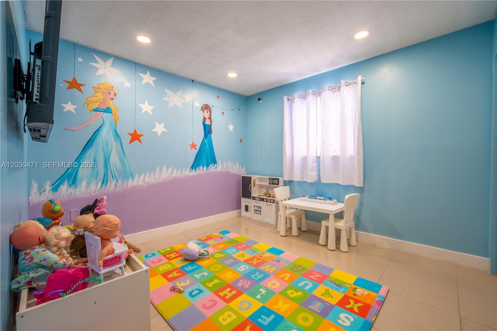 A children's playroom features light blue walls, a Frozen-themed mural, and a colorful alphabet rug — 11851 SW 181st St, Miami FL 33177, MIAMI, FL