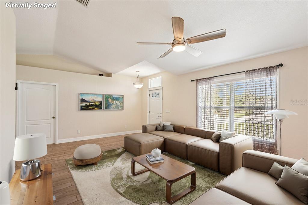 An empty room with light-colored walls, wood-look tile flooring, a ceiling fan, and a window — 1929 NORVELL AVENUE, NORTH PORT, FL
