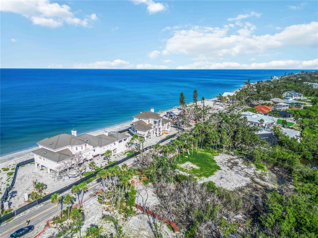 An aerial view of a coastal property featuring two large houses near the ocean — 6845 MANASOTA KEY ROAD, ENGLEWOOD, FL
