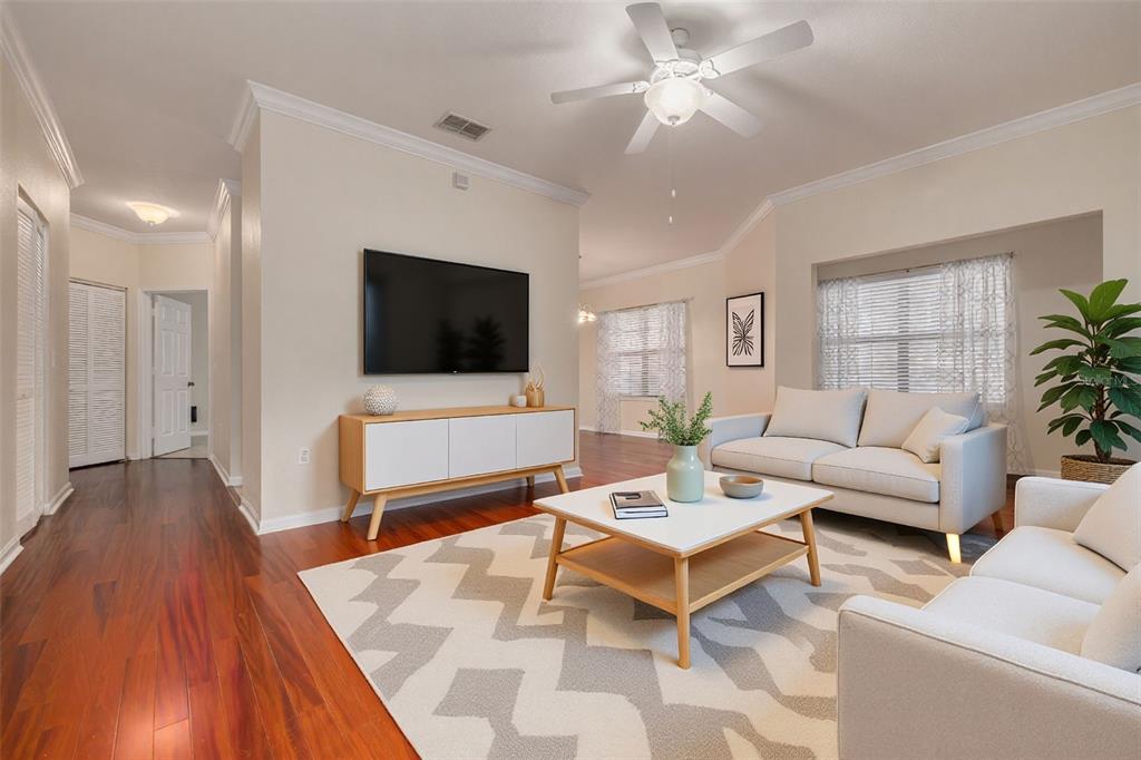 A two-story apartment building with tan stucco walls, red trim, and a surrounding lawn — 2262 CHIANTI PLACE UNIT 5-0511, PALM HARBOR, FL