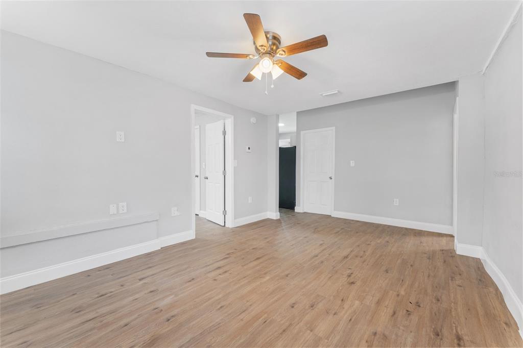 An empty room with light gray walls, wood-look flooring, and a ceiling fan — 1927 13TH STREET S, ST PETERSBURG, FL