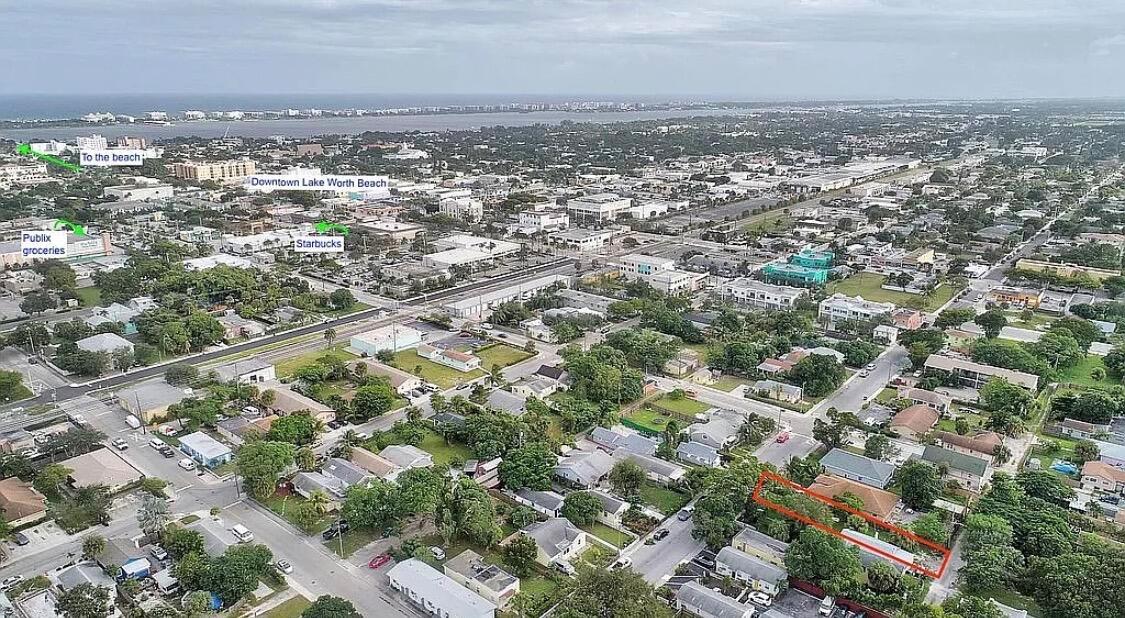 Aerial view of a residential neighborhood with a highlighted property and nearby local landmarks — 211 N E Street, FL 33460, FL