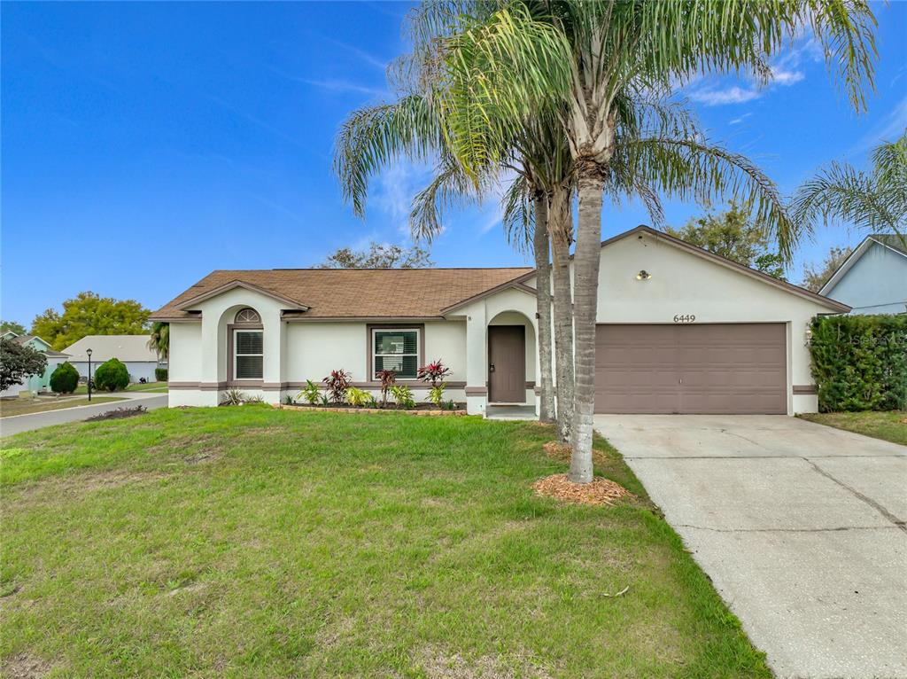 An aerial view of a single-story house with a brown shingled roof and palm trees — 6449 ROYAL TERN STREET, ORLANDO, FL
