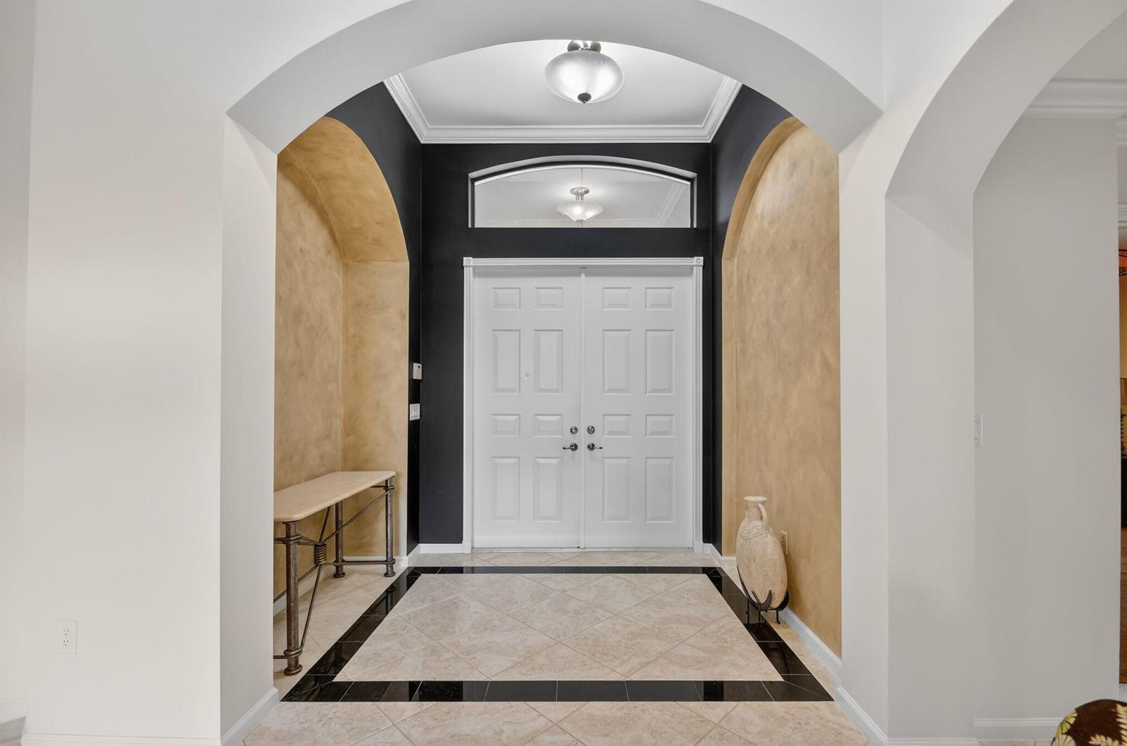 An entryway features a double door, arched alcoves with faux-finish walls, and tiled flooring — 8046 Via Grande, Boynton Beach FL 33437, BOYNTON BEACH, FL