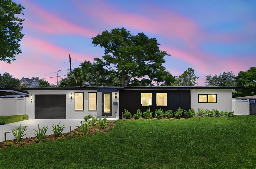 A single-story house with a black and white exterior, a garage, and a large tree — 3006 NORTHWOOD BOULEVARD, WINTER PARK, FL