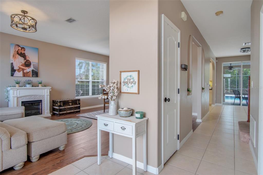 A living room with a fireplace and a hallway with tile flooring are visible — 159 RED MAPLE BURL CIRCLE, DEBARY, FL