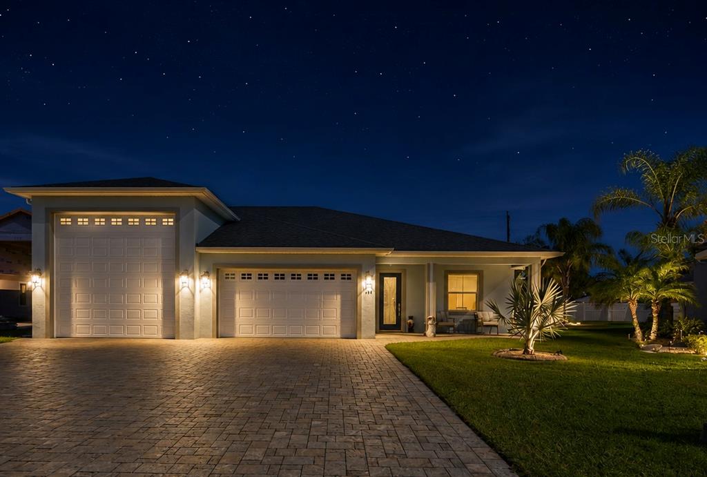 A single-story house with a paved driveway, two garage doors, and a landscaped front yard — 149 LAYNEWADE ROAD, POLK CITY, FL