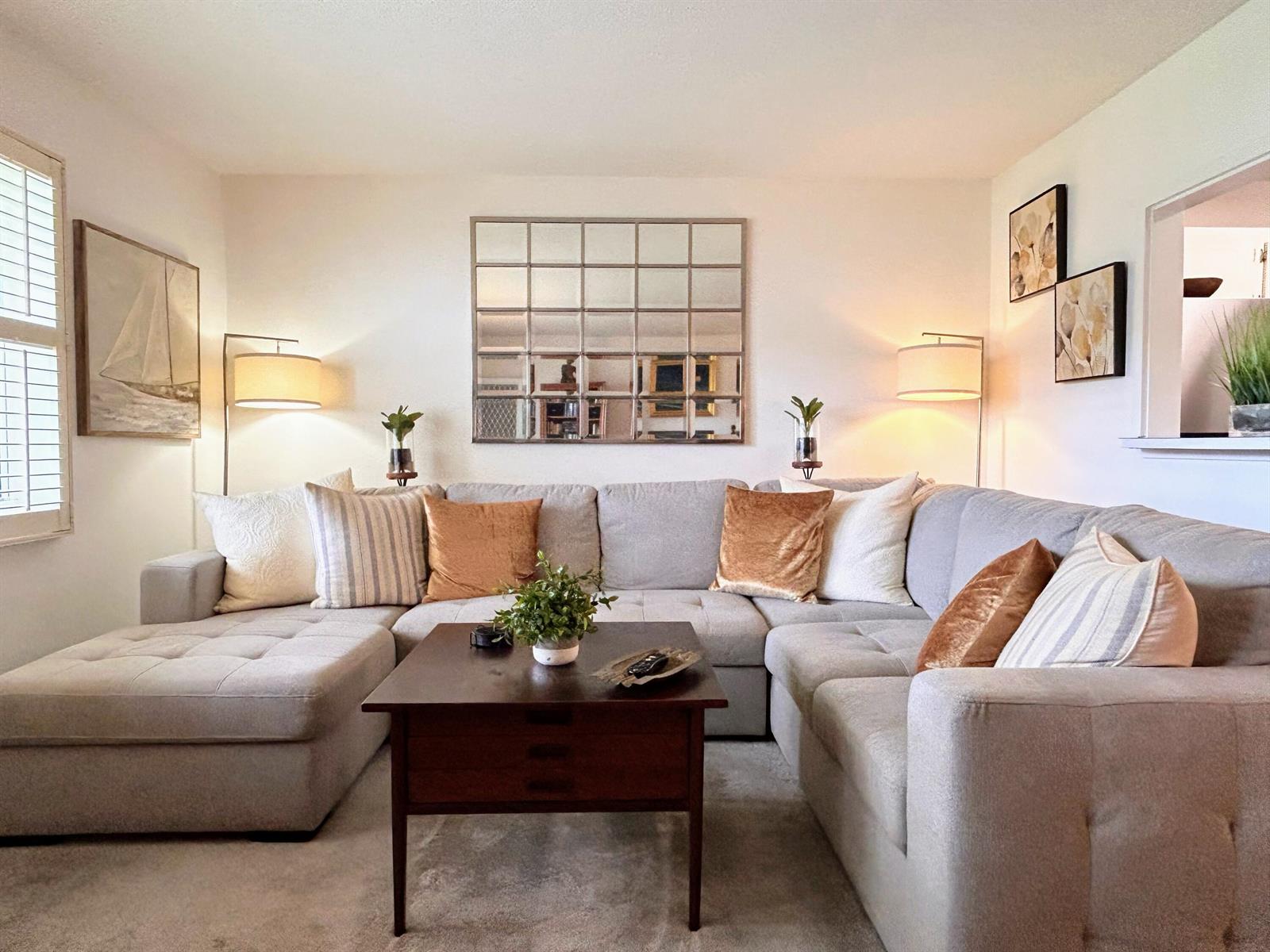A living room features a large gray sectional sofa, a dark wood coffee table, and a mirror — 320 Horizons # 103, Boynton Beach FL 33435, BOYNTON BEACH, FL