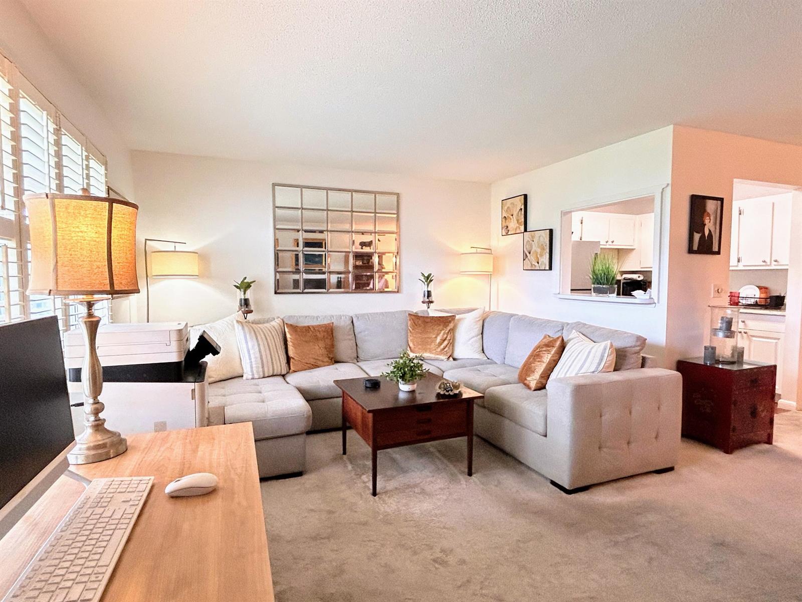 A living room features a large gray sectional sofa, a coffee table, and a desk — 320 Horizons # 103, Boynton Beach FL 33435, BOYNTON BEACH, FL