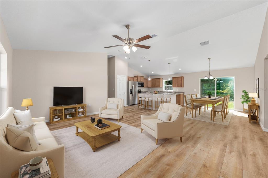 A single-story house with a light green exterior, a two-car garage, and a concrete walkway — 5676 N SUMMERFIELD POINT, CITRUS SPRINGS, FL