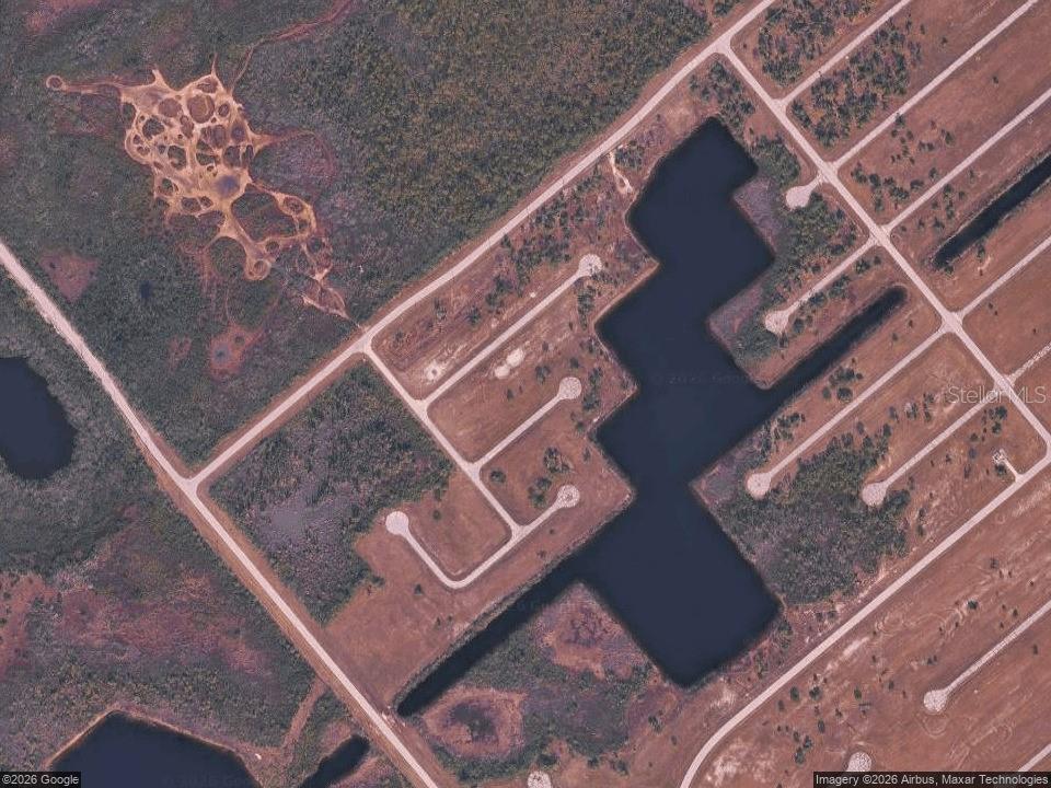 An aerial map view shows a vacant lot with a large pond and road infrastructure — 14108 TILEFISH COURT, PLACIDA, FL