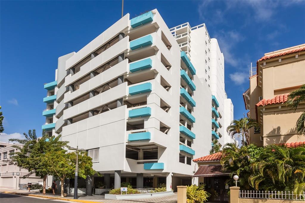 A multi-story white parking garage building features blue accents and an adjacent taller white tower — 1315 ASHFORD AVENUE AVENUE UNIT 905, SAN JUAN, PR
