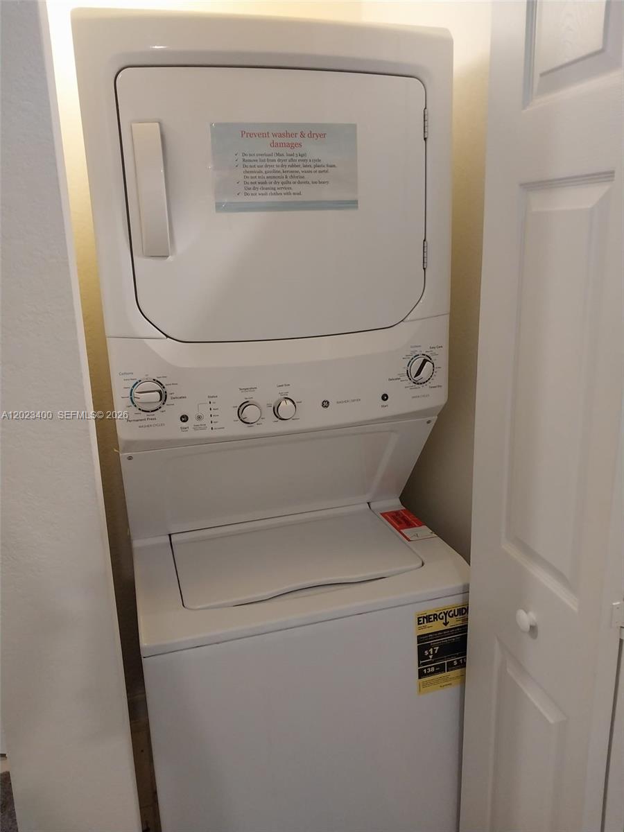 An empty room with beige tile flooring and a doorway leading to a driveway — 9261 W 33rd Way, Hialeah FL 33018, HIALEAH, FL