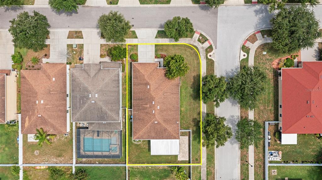 An aerial view shows a single-family home with a large side yard on a corner lot — 2719 CYPRESS BOWL ROAD, LUTZ, FL