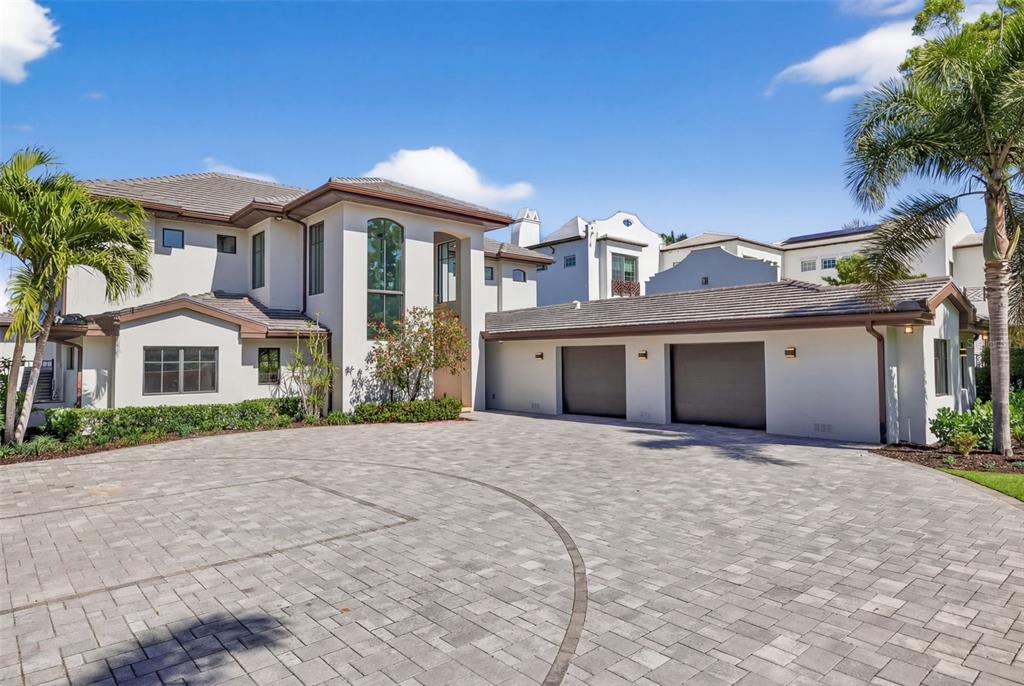 A large two-story house with a paved circular driveway and an attached three-car garage — 460 COFFEE POT RIVIERA NE, ST PETERSBURG, FL