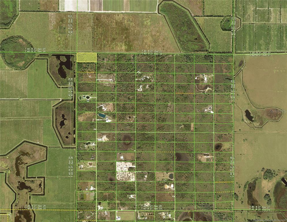 This is an aerial map showing a rectangular parcel of land highlighted in yellow — 50032 BERMONT ROAD, PUNTA GORDA, FL