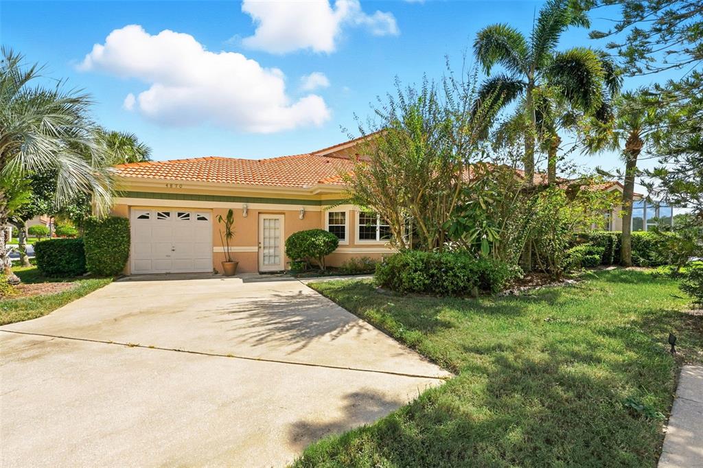 A single-story house with a tile roof, a one-car garage, and a concrete driveway — 4870 WATERVISTA DRIVE, ORLANDO, FL
