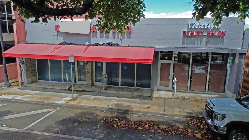 A commercial building exterior with a red awning, glass storefronts, and a for rent sign — 1365 SW 22nd Street, Miami FL 33145, MIAMI, FL