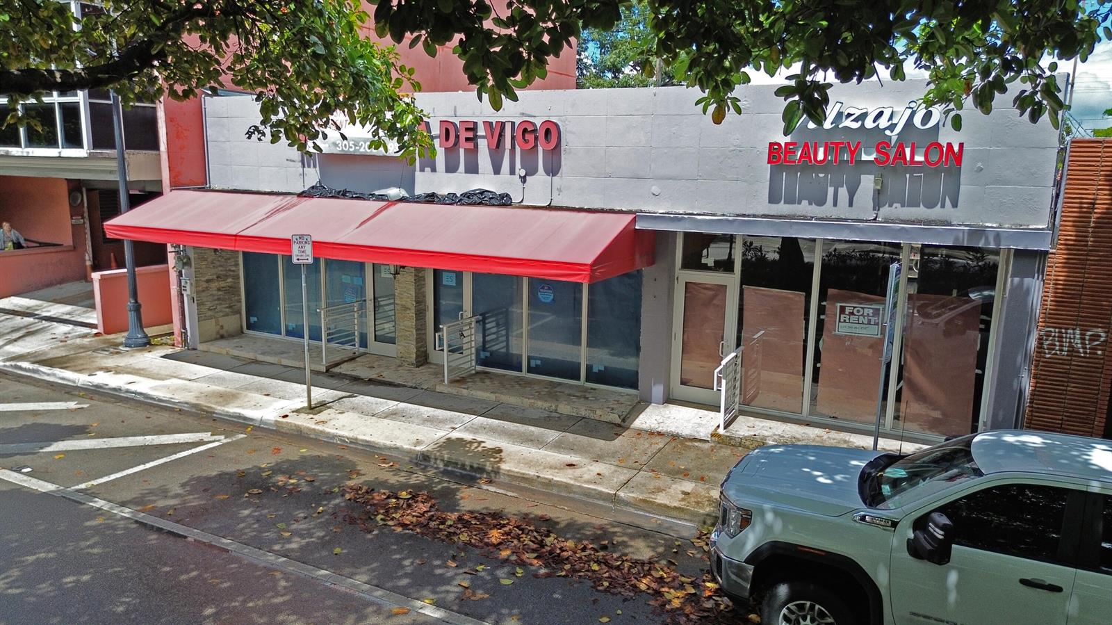 An exterior view of a commercial building with a red awning and storefront windows — 1365 SW 22nd Street, Miami FL 33145, MIAMI, FL