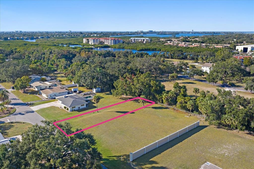 An aerial view shows a vacant rectangular lot outlined in pink next to residential houses — SOUTHWOOD STREET, SARASOTA, FL