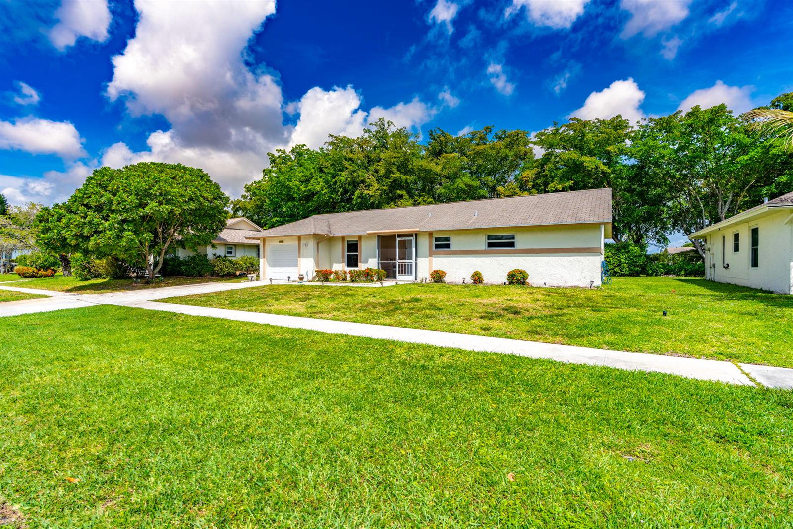 A single-story house with a beige exterior, a brown roof, and a large front lawn — 14759 Hideaway Lane, Delray Beach FL 33484, DELRAY BEACH, FL